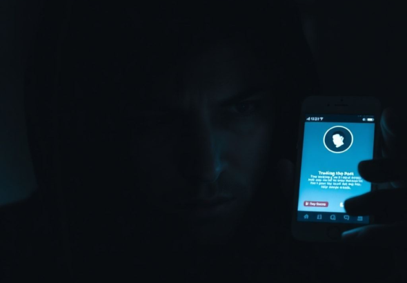 A person's face hidden in shadows, illuminated by the cold glow of a smartphone screen displaying a tracking app, their expression a mix of anxiety and guilt, in a dimly lit room, focusing on the emotional toll of secret surveillance, cinematic atmosphere, dark color palette, highly detailed, realistic